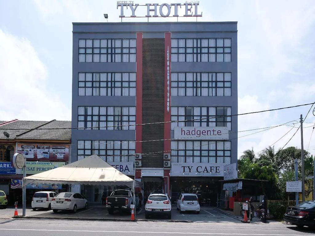 a large building with cars parked in a parking lot at TY Hotel in Kuala Terengganu