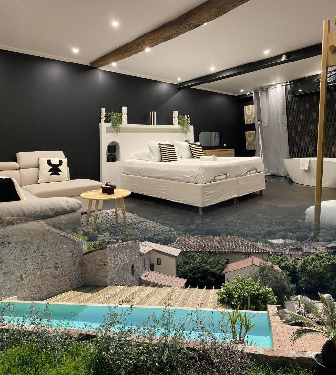 a living room with a large bed and a couch at Mas Beauregard in Anduze
