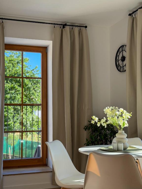 a dining room with a table and a window at Spim na Rabí in Raby
