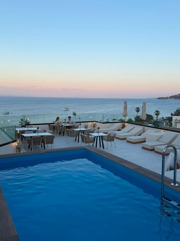 a swimming pool with a view of the ocean at Palatino Hotel in Zakynthos