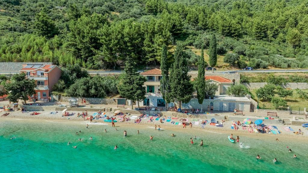 a group of people on a beach in the water at Beachfront Villa San't Antonio Podaca in Podaca
