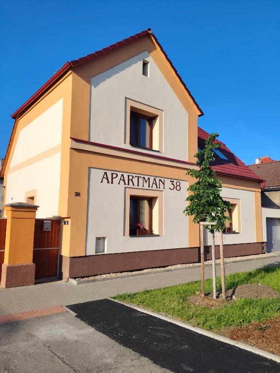 a building with a sign that reads apartment at Apartmán 38 in Opolany