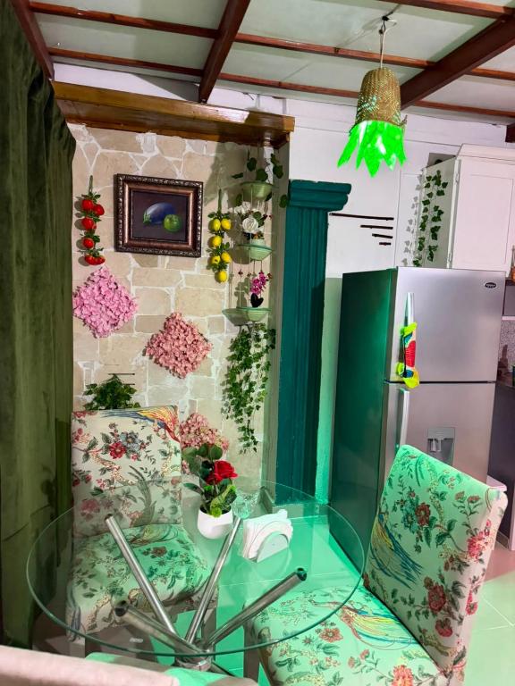 a glass table and a chair in a kitchen at Valle Narural in Manoguayabo