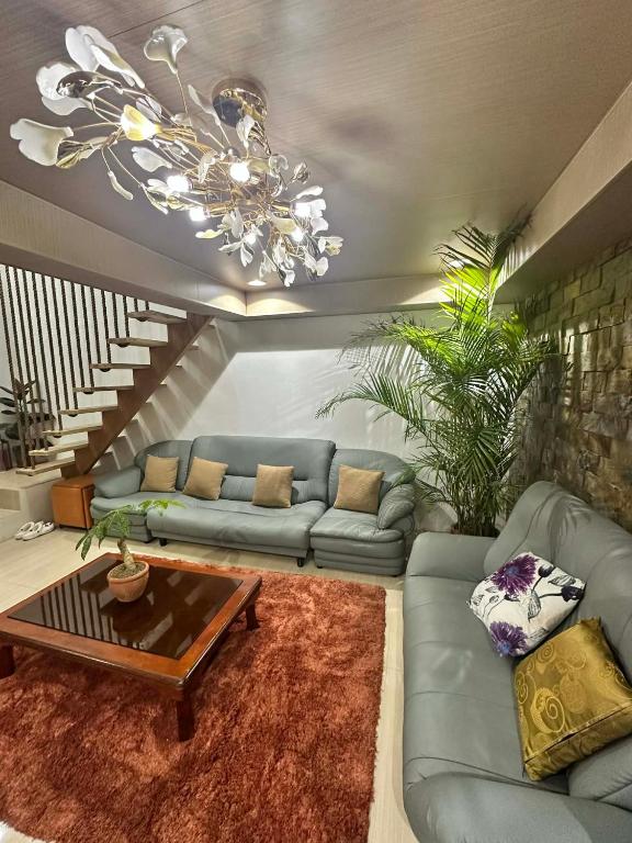 a living room with a couch and a table at A.C. Asistin Transient House in Baguio