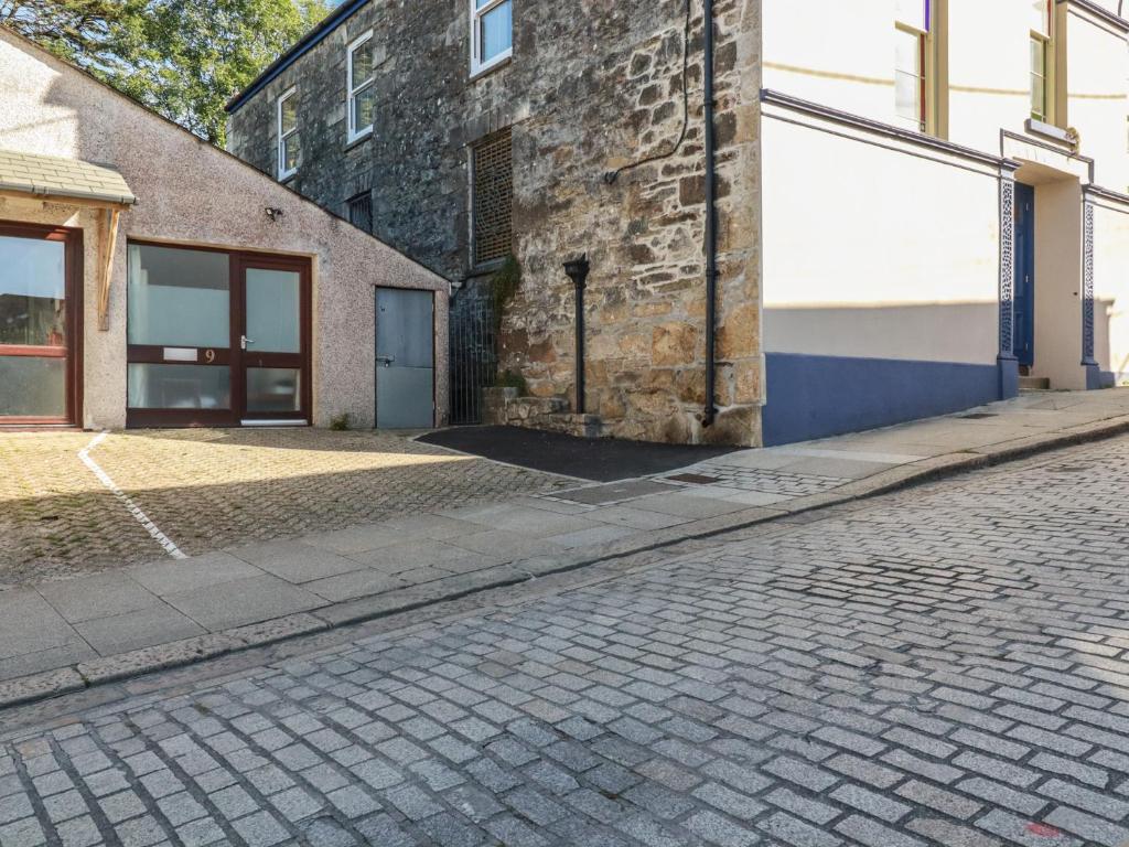 an empty street next to a brick building at Newseal House in St Austell