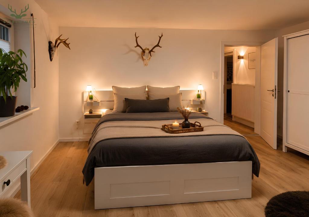 a bedroom with a large bed with two lights on it at Gästezimmer Eifelglück - ohne Küche in Pelm