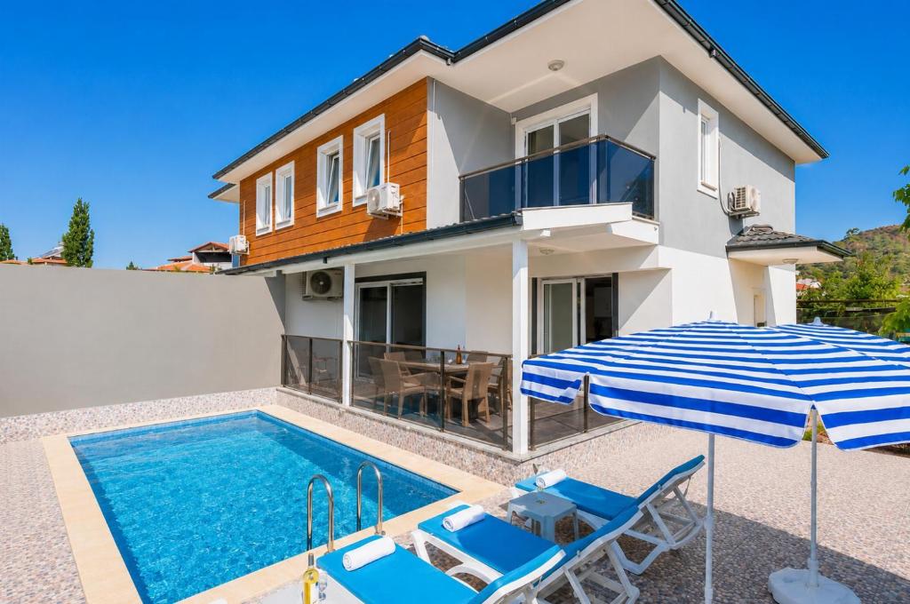 a villa with a swimming pool and a house at Villa Azalea 2 in Ortaca