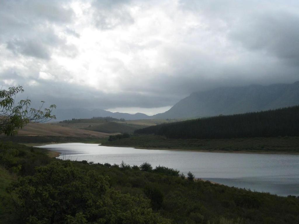 a large body of water with mountains in the background at Korentepoort Dam in Riversdale
