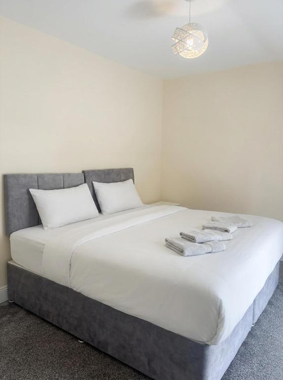 a large white bed with white towels on it at Jennys Bar in Mullagh