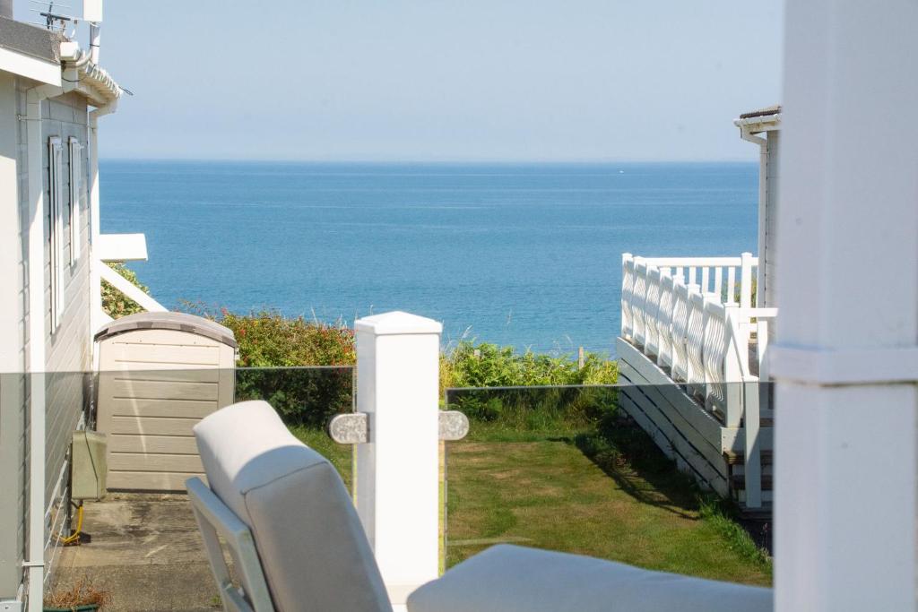 a view of the ocean from the balcony of a house at Sea View Lodge in Nefyn