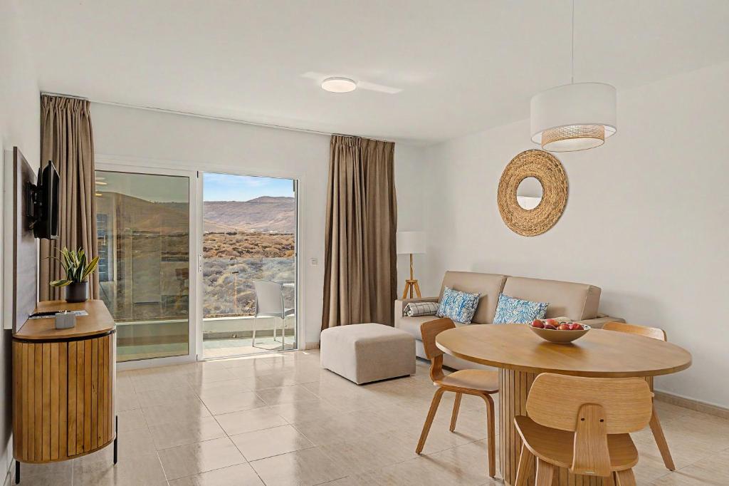 a living room with a table and a couch at Callao Beach 10 in Arrieta