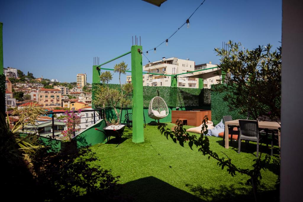 a view of a yard with a swing on a balcony at Rooftop Apartment with Garden and Jacuzzi in Durrës