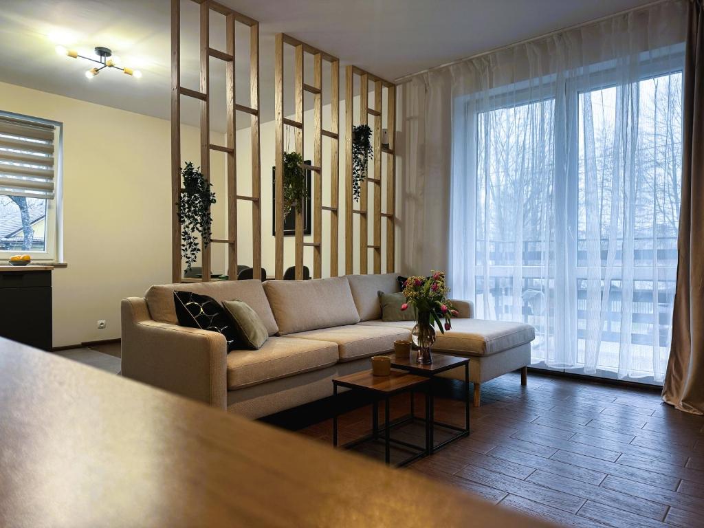 a living room with a couch and a table at Apartament Słoneczny 31 in Czechowice-Dziedzice