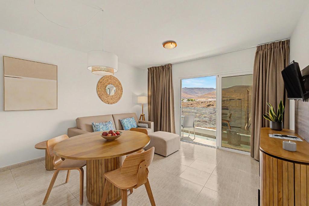 a living room with a table and a couch at Callao Beach 9 in Arrieta