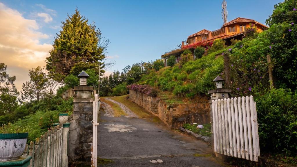 a house on top of a hill with a fence at Ivy Hill in Yedapalli