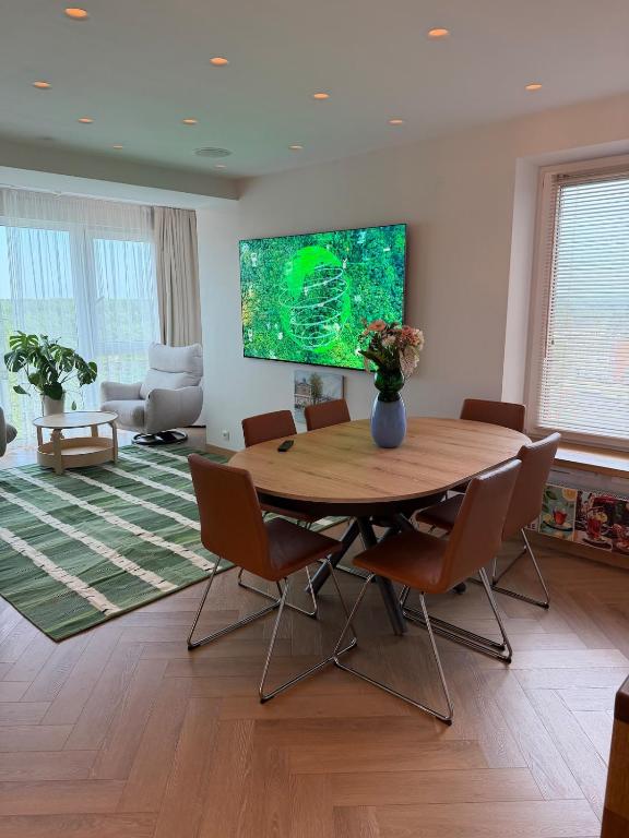 a living room with a table and chairs and a television at ViSky Ap in Visaginas