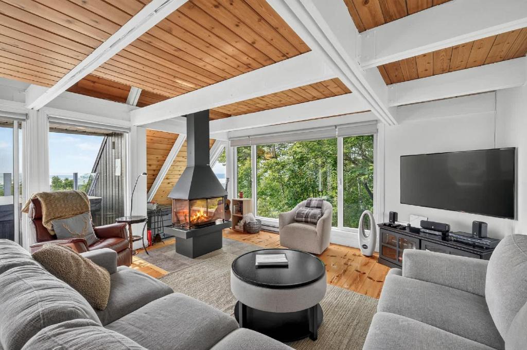a living room with a couch and a fireplace at The Perch - Spa & Pool in Beaupré