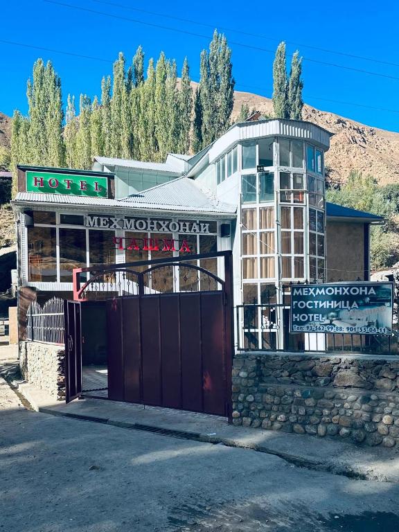 a hotel with a gate in front of a building at Chashma in Ishkashim