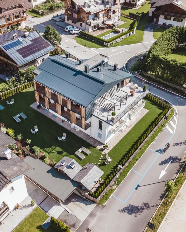 an overhead view of a building with a blue roof at Ariane's Guesthouse - 3 Zinnen Dolomites in Sesto