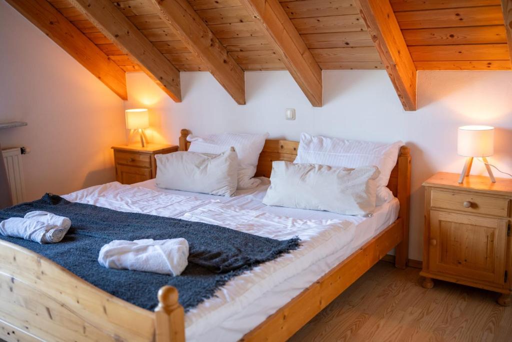 a bedroom with a large bed with white sheets and pillows at Landhaus Schneeberg AusZeit am Küppel & Bright Collection in Gersfeld
