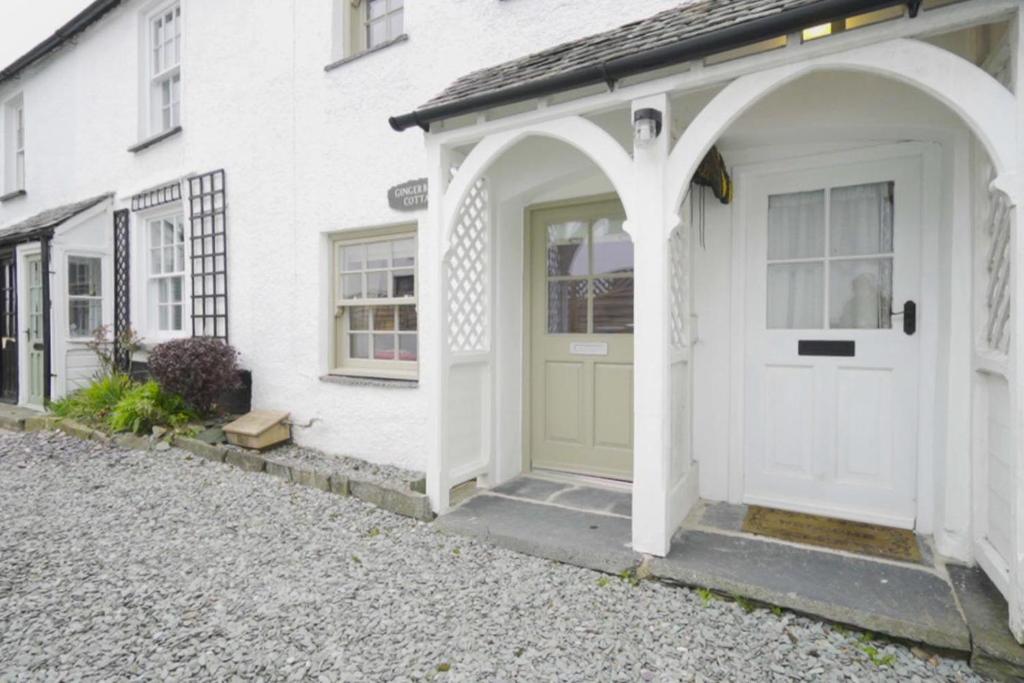 a white house with a green door at 1 Bed in Hawkshead oc-lr067 in Hawkshead