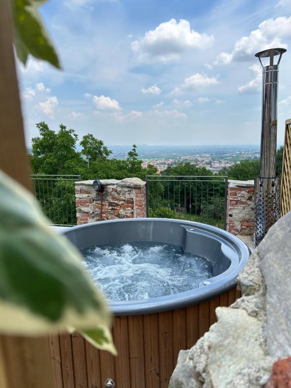 a hot tub with water in it on a patio at Da Noi Panoramic Guest Stay Camera Orizzonte in Cuorgnè
