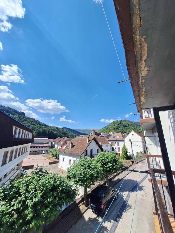 a view from a balcony of a town with a car at Apartamento ARBEA in Ochagavía