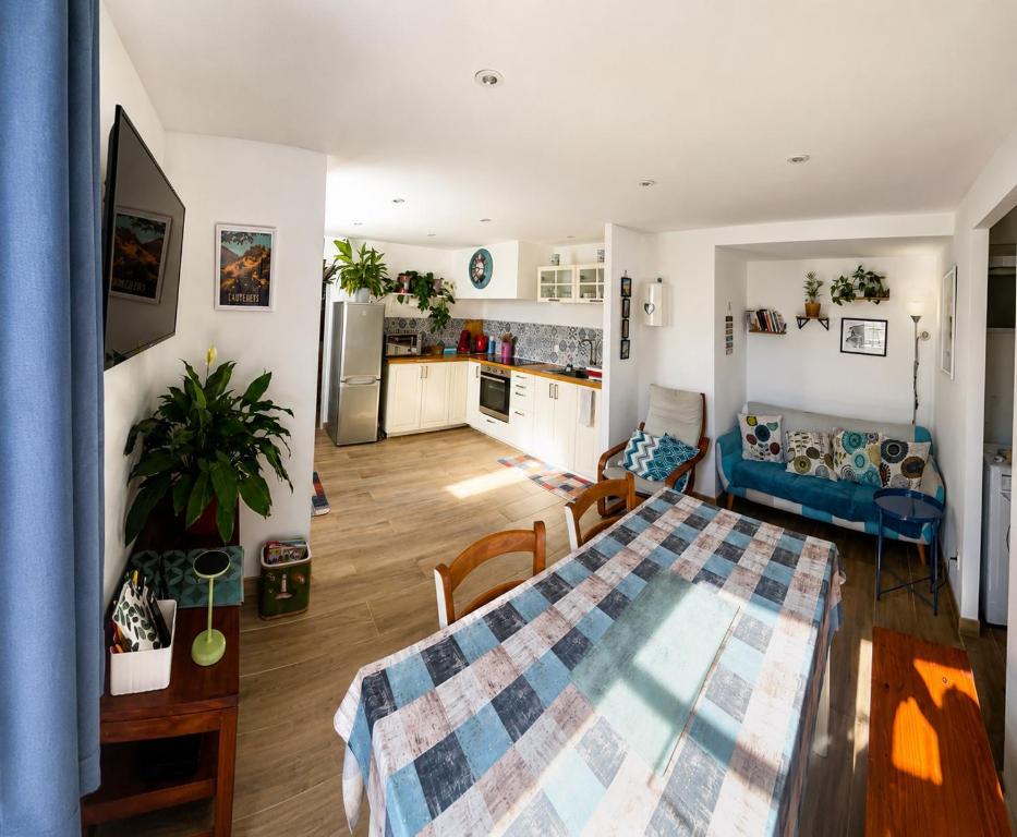a kitchen and a living room with a table and a living room at Entre Mer et Montagnes in Céret