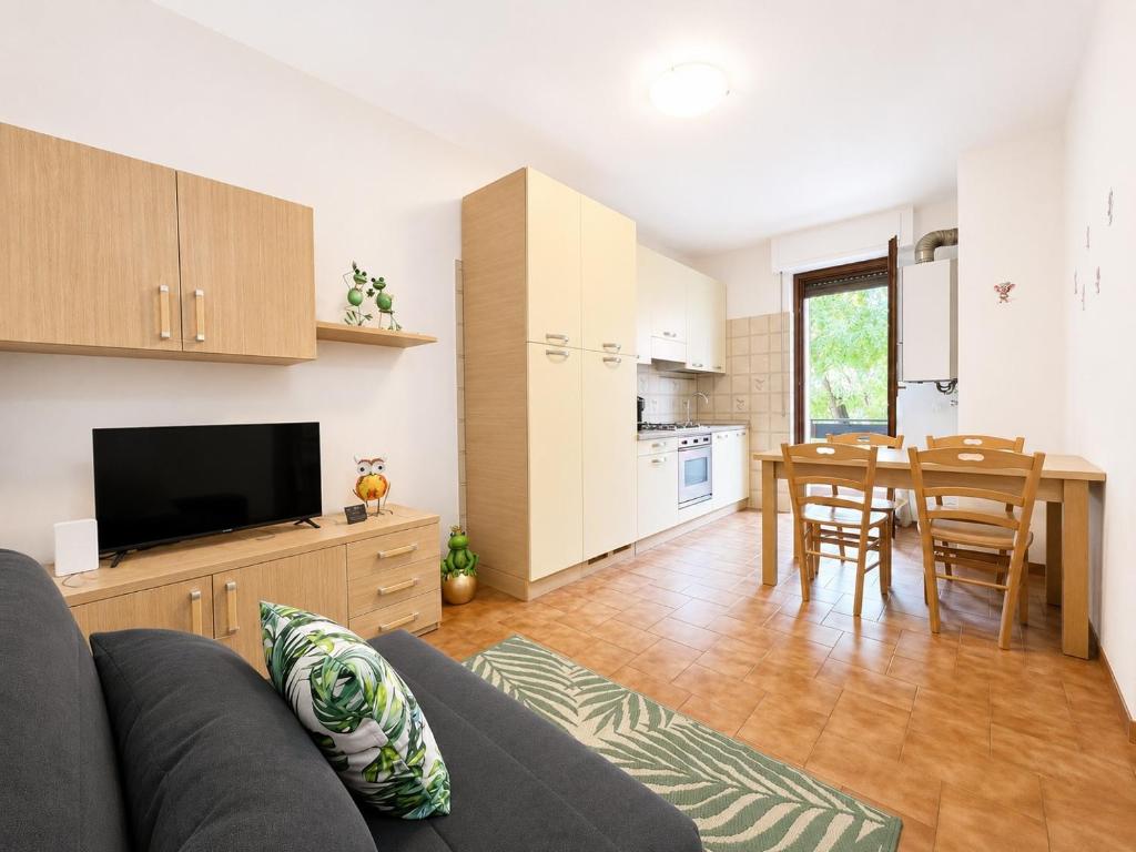 a living room with a couch and a kitchen with a table at Bella Vita Stays Easy in Sondrio