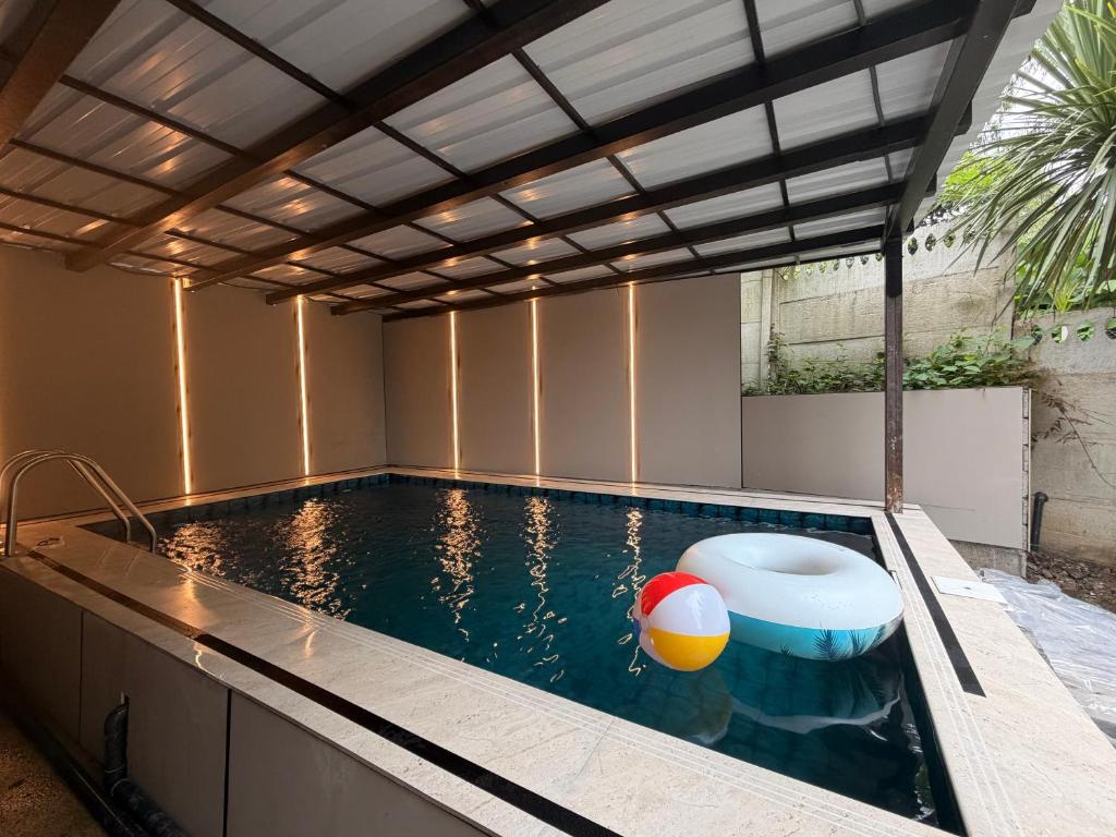 a swimming pool with a pergola over it at Villa TG for Large Families with Private Pool in Batumi