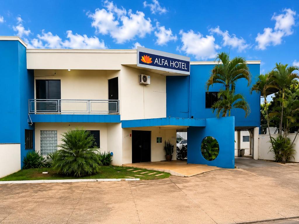 a blue and white building with a sign on it at Alfa Hotel Nova Mutum in Nova Mutum