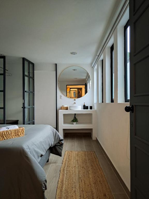 a bedroom with a bed and a mirror on the wall at Casa Puerto Siete8 in Mexico City