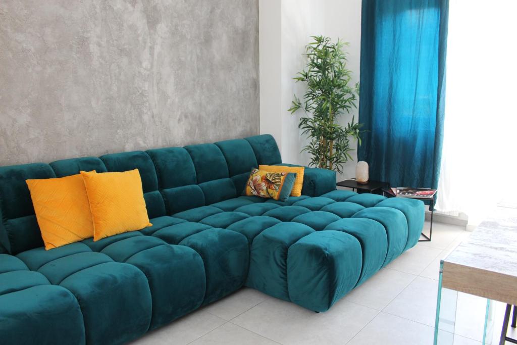 a large blue couch in a living room at Glycine House in Varese