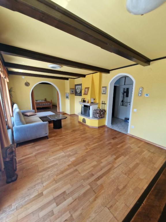 a large living room with a couch and a table at Apartma Regrat in Lesce