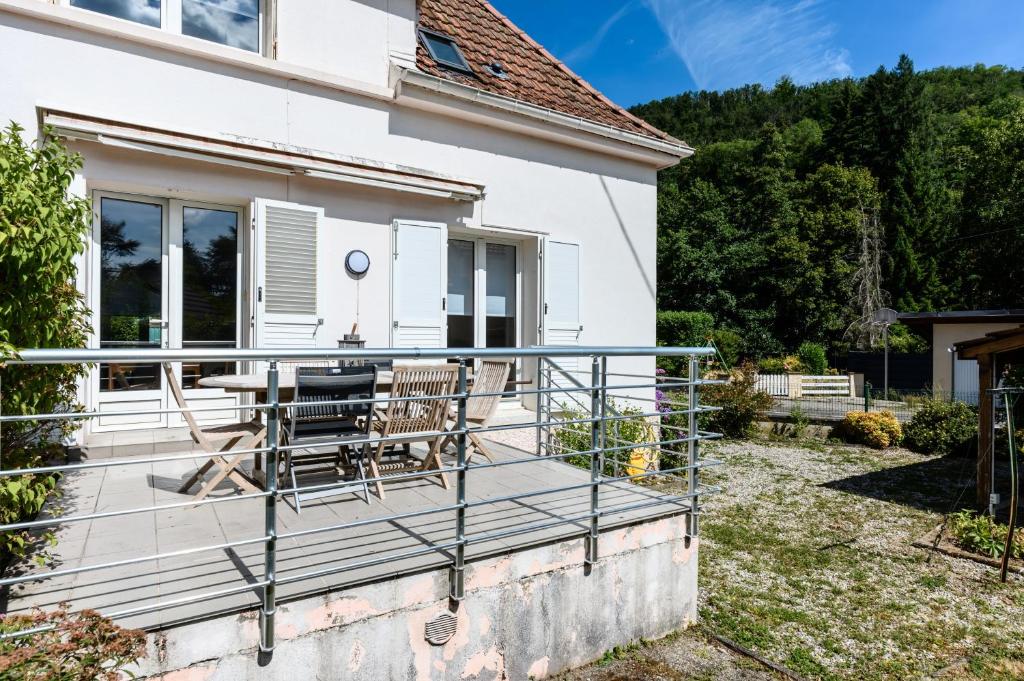 a balcony of a house with a table and chairs at Maison La Mirabelle in Thann