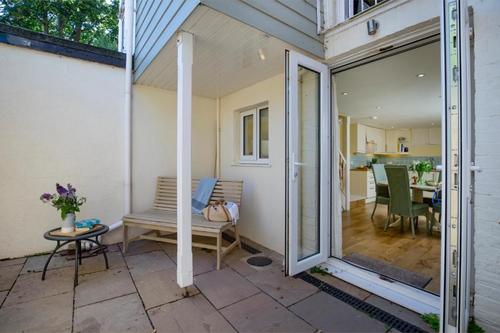 a sliding glass door leading to a patio with a table at 1 Abiff Place in Sidmouth