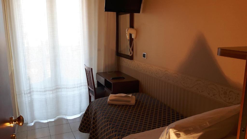 Postel nebo postele na pokoji v ubytování Hotel Grifone