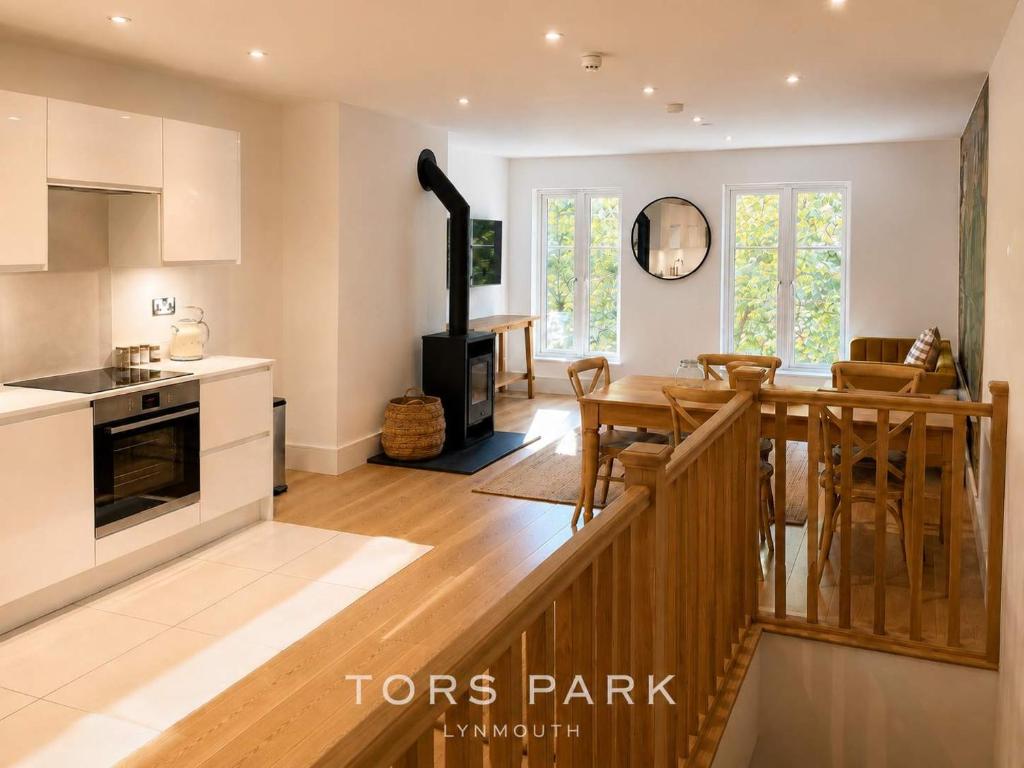 a kitchen and living room with a table and a stove at Watersmeet Point in Lynmouth
