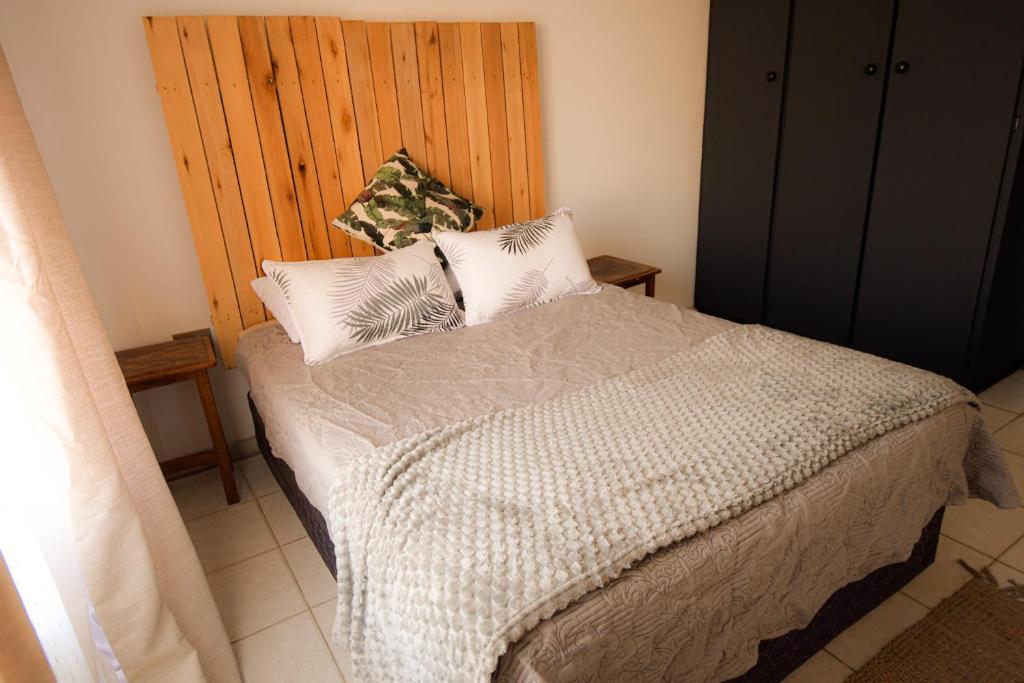 a bedroom with a bed with two pillows on it at Melvillas in Louis Trichardt