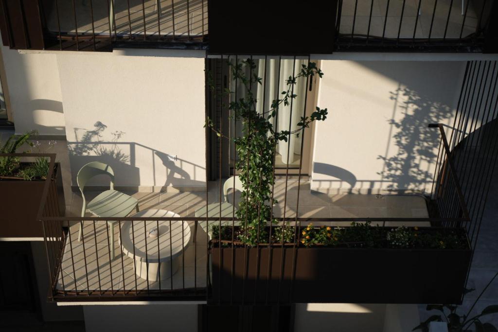a building with a balcony with plants on it at Phi Aegina in Agia Marina Aegina