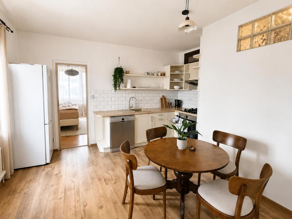 a kitchen and dining room with a table and chairs at Apartmán Malohont in Rimavská Sobota