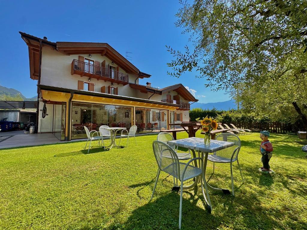 a table and chairs in front of a house at Agritur Girardelli in Riva del Garda