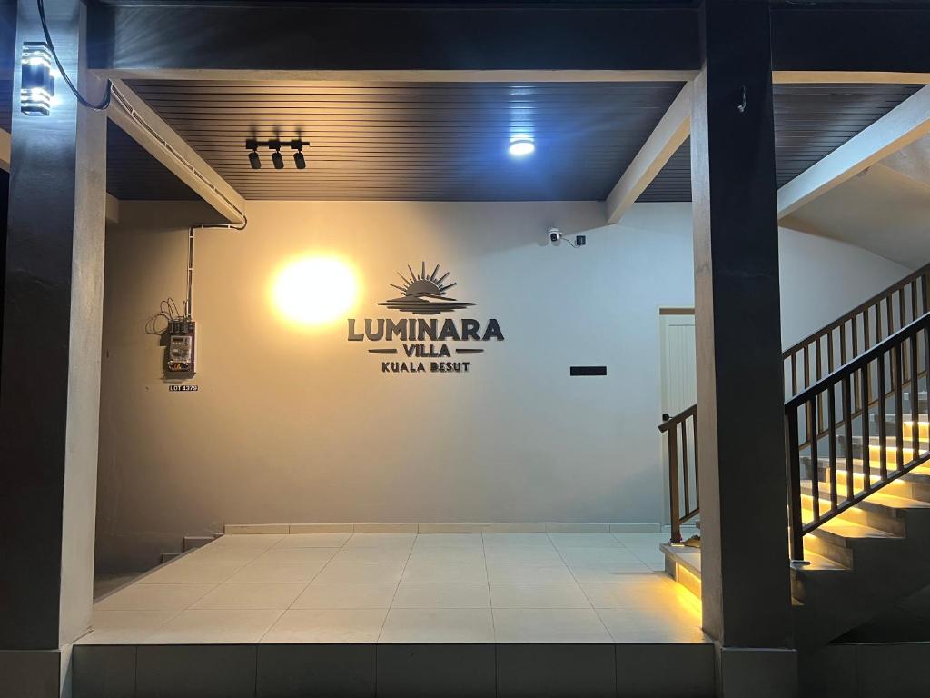 a lobby with a sign on the wall of a building at Luminara Villa Kuala Besut in Kampung Kuala Besut