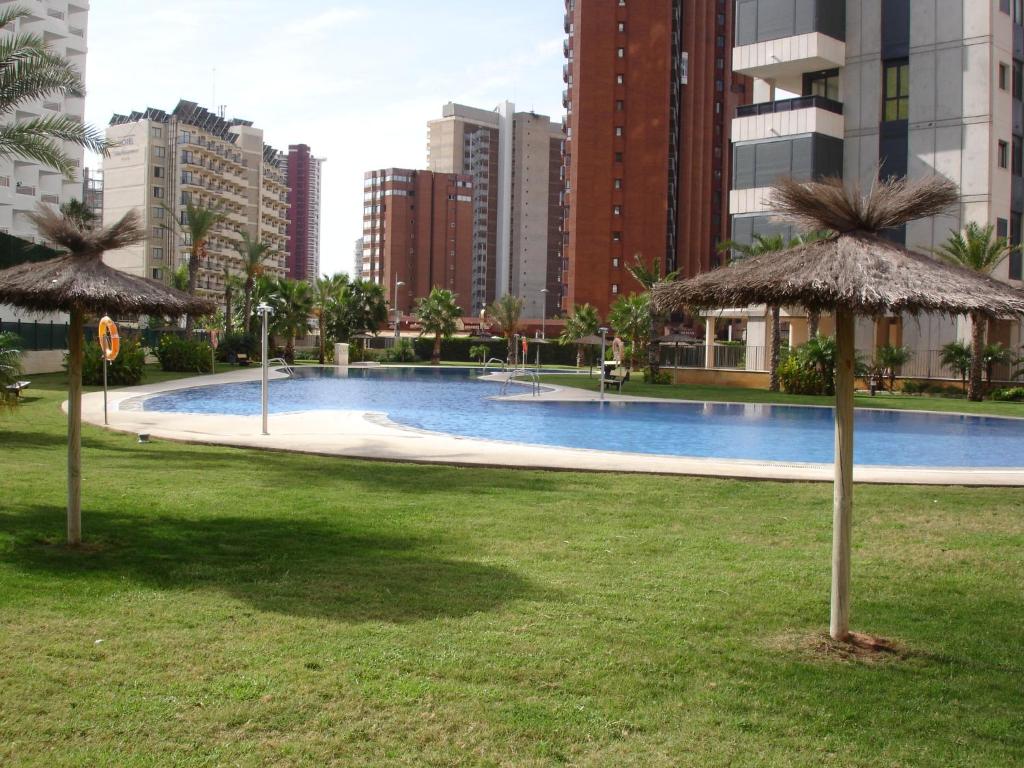 a large swimming pool in a city with tall buildings at Gemelos 26 - Zand Properties in Benidorm