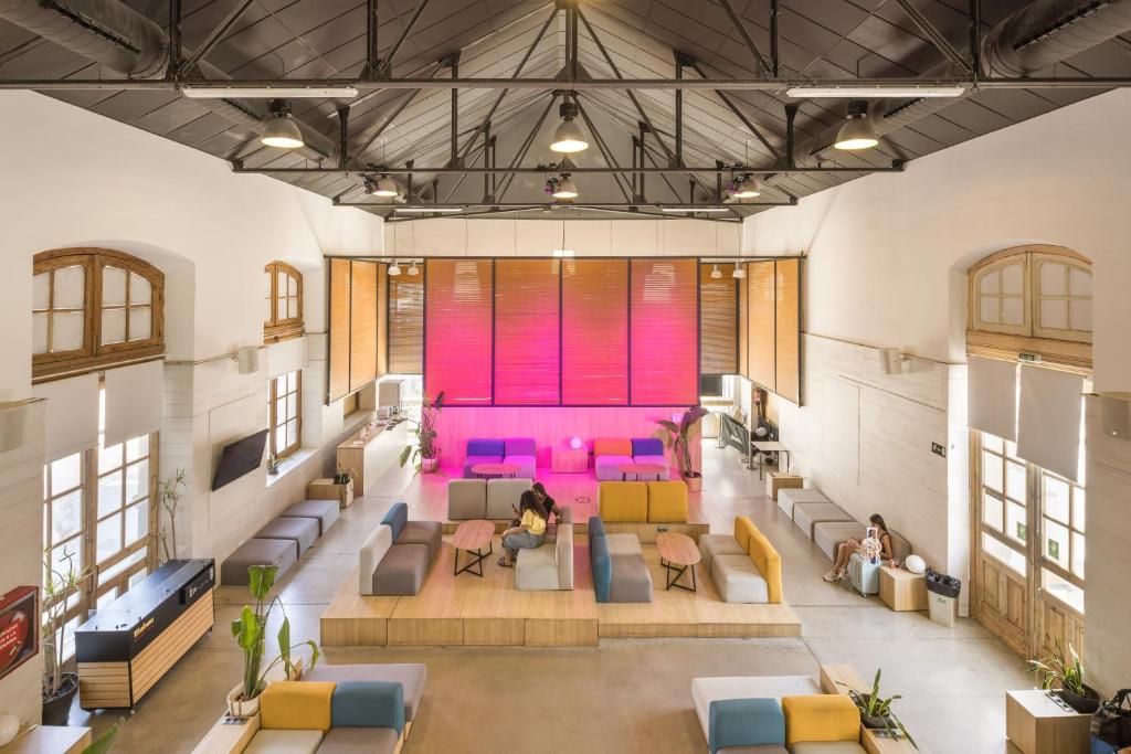 an overhead view of a living room with colorful furniture at UP Hostel Valencia in Valencia