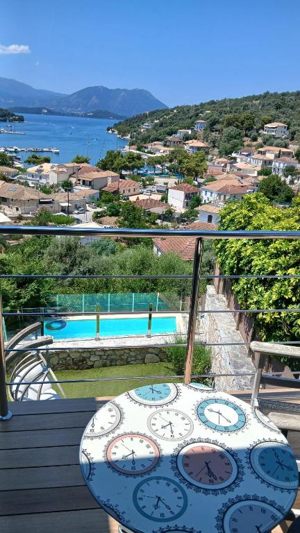 a balcony with a table and a view of a pool at Villa Lydia in Meganisi