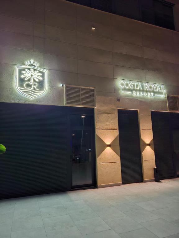 a building with two doors and a sign on it at Costa Royal Resort in Villajoyosa