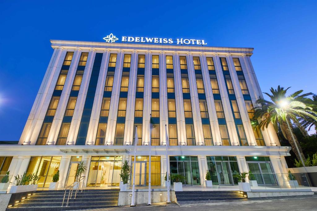 a building with a sign on the top of it at EDELWEISS HOTEL El Mouradia in El Mouradia