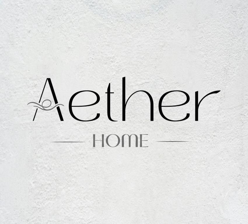 a kitchen home logo on a white wall at Aether Home in Ammoudia