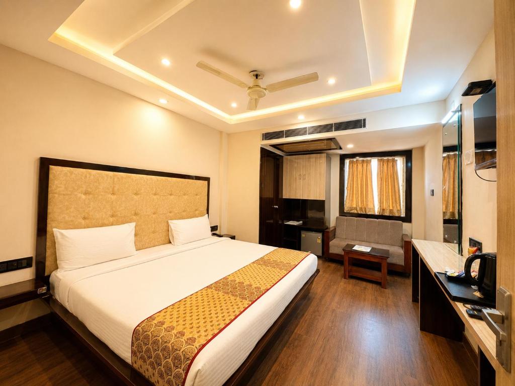 a hotel room with a bed and a television at Hotel A One Luxury - Premium Stay Puri Beach in Puri